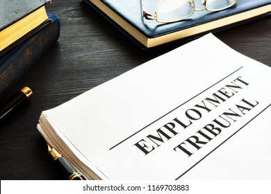 Employment tribunal documents, note pad and glasses. - Shutterstock ID 1169703883