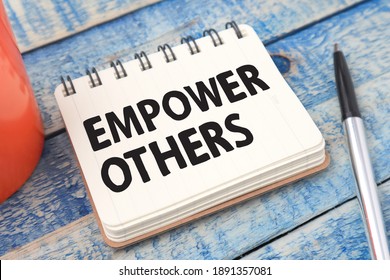 Empower Others, Text Words Typography Written On Paper Against Wooden Background, Life And Business Motivational Inspirational Concept