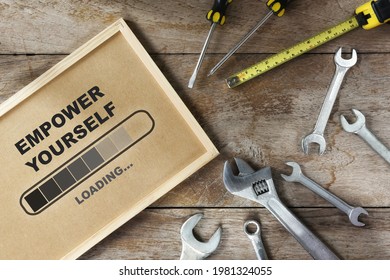Empower yourself loading on wooden board and tools supplies on wooden background. Optimism success business concept and teamwork idea