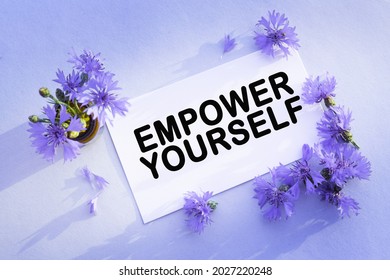 EMPOWER YOURSELF text. Cyanus segetum on the blank white greeting card for congratulations .