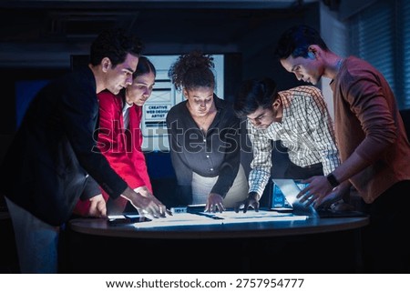 Empowering diverse STEM workforce. Engineering team analyzing interactive digital layouts. Driving creative app innovation in modern workspace.