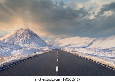 Empty A82 Road Blank Horizon Dramatic Winter Snow At Sides In Scottish Highlands At Glencoe Rannoch Moor Buachaille Etive Mor Mountain Scotland Centered White Lines