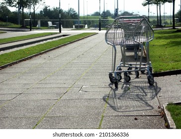 Empty Abandoned Metal Shopping Trolley In A Shopping Mall Car Park In The Sunshine