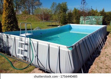 Empty Above Ground Swimming Pool In A Backyard