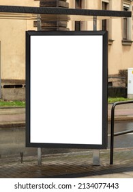 Empty Advertisement Display At A Bus Shelter In A City. Blank Billboard Mockup For Marketing In The Public Sphere. Template For Testing The Design Of An Ad Next To A Street.