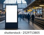 Empty advertising billboard at a train station platform with people walking in the background. Copy space for advertising mockups, commercial concepts, urban transportation, and travel projects