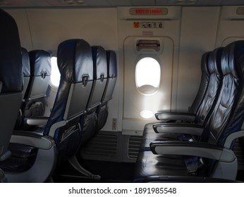 Empty Airplane Seat And Window. Aircraft Exit Door. Emergency Use Only.