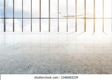 Empty airport hall with window of glass and flying airplane over blue sky background
