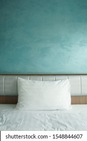 Empty And Alone White Pillow On Bed And Wood Headboard In Bedroom On Vintage Blue Wall Background And Feel Lonely Or Nobody With Cool Tone For Winter Christmas And Vertical