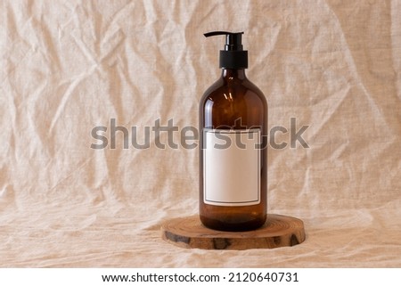 Empty amber glass soap or shampoo bottle on isolated background. Skin care or hair concept with natural cosmetics.