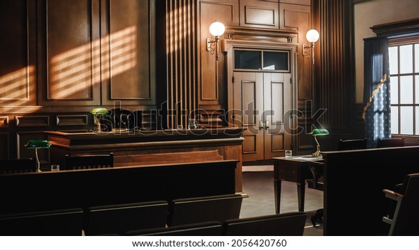 Empty American Style Courtroom. Supreme Court of\
Law and Justice Trial Stand. Courthouse Before Civil Case Hearing\
Starts. Grand Wooden Interior with Judge\'s Bench, Defendant\'s and\
Plaintiff\'s Tables.