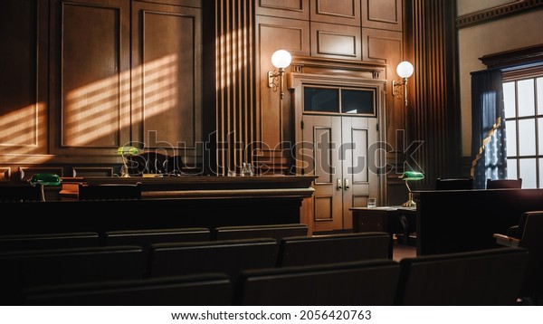 Empty American Style Courtroom. Supreme Court of\
Law and Justice Trial Stand. Courthouse Before Civil Case Hearing\
Starts. Grand Wooden Interior with Judge\'s Bench, Defendant\'s and\
Plaintiff\'s Tables.