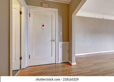 Empty Apartment. Entrance Hallway With White Door And Old Hardwood Floor