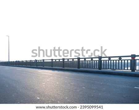 Empty asphalt Bangladeshi riverside bridge road in sunset time with blue cloudy winter sky with sun ray. New modern highway concrete construction. Concept of way to success. Transportation logistic