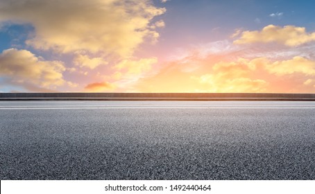 Empty asphalt highway and beautiful sky clouds at sunset