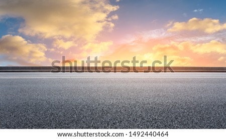 Empty asphalt highway and beautiful sky clouds at sunset