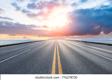 empty asphalt highway and blue sea nature landscape at sunset - Shutterstock ID 776278720