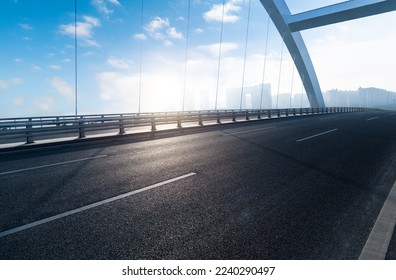 Empty asphalt highway bridge of city under blue sky