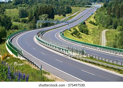 Empty Asphalt Highway With Electronic Toll Gates In A Wooded Landscape. View From Above. Sunny Summer Day.