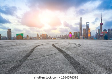 Empty Asphalt Race Track And Modern City Skyline In Shanghai At Sunset.