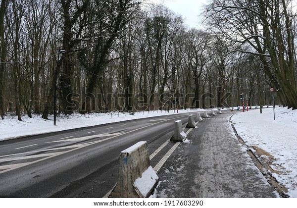 An empty asphalt road after cleaning\
from snow in Brussels, Belgium on February 10,\
2021.