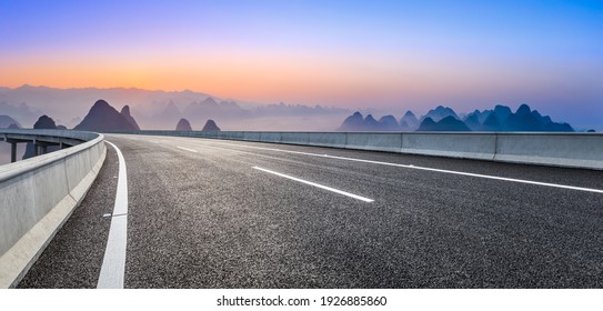 Empty asphalt road and beautiful mountains at sunrise in Guilin,China. - Powered by Shutterstock