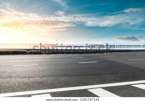 Empty asphalt road and beautiful West Lake\
scenery in Hangzhou