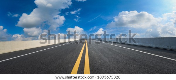 Empty asphalt road and blue sky with white
clouds.Road background.
