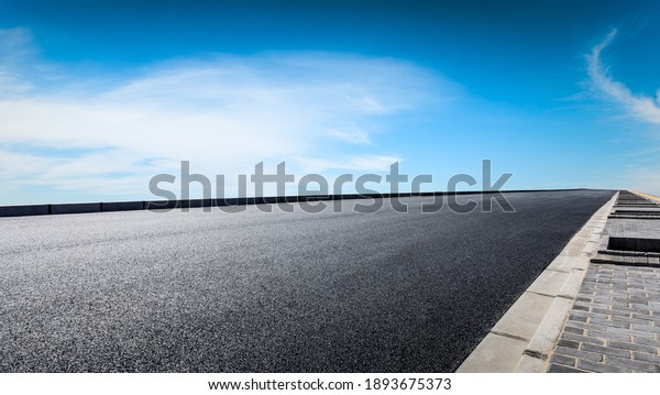 Empty asphalt road and blue sky with white
clouds.Road background.