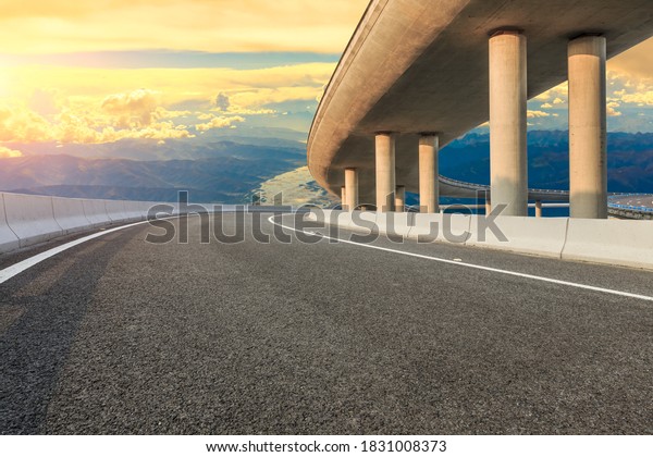 Empty\
asphalt road and Bridge with mountain\
scenery.