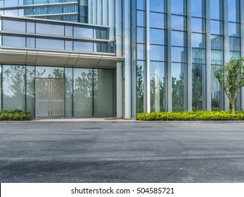 Empty Asphalt Road By Modern Office Building.