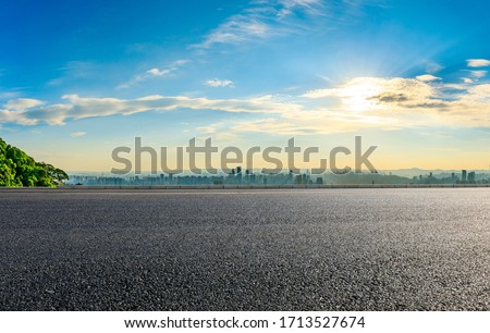 Empty asphalt road and Chongqing city skyline and buildings at sunset,China.