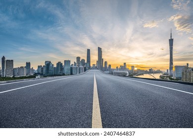 Empty asphalt road and city buildings landscape at night in Guangzhou - Powered by Shutterstock