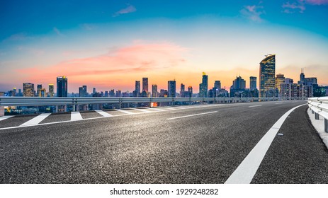 Empty asphalt road and city skyline with buildings at sunset in Shanghai. - Shutterstock ID 1929248282