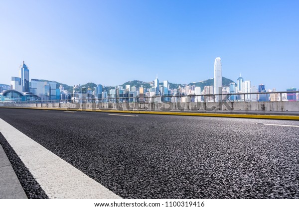 empty\
asphalt road with city skyline in hongkong\
china