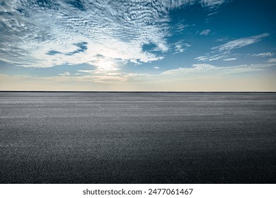 Empty asphalt road and cloudscape on sunny day