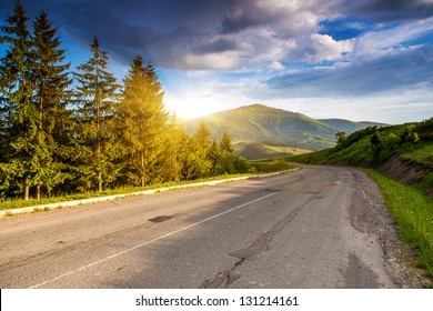 Empty asphalt road with cloudy sky and sunlight