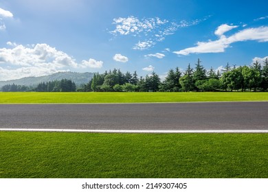 Empty Asphalt Road And Forest With Mountain Nature Landscape Under Blue Sky