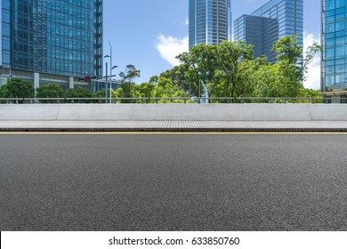 empty asphalt road front of modern buildings