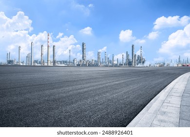 Empty asphalt road and industrial buildings background