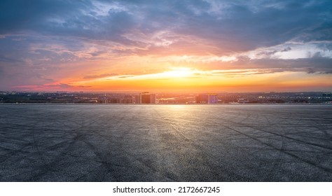 Empty asphalt road and modern city skyline with building scenery at sunset. high angle view.