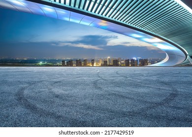 Empty Asphalt Road And Modern City Skyline With Building Scenery At Sunset. High Angle View.