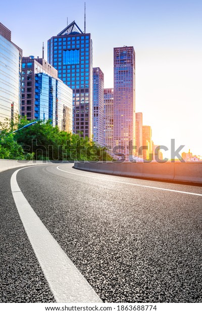 Empty asphalt road and modern cityscape in\
Beijing at sunset,China.