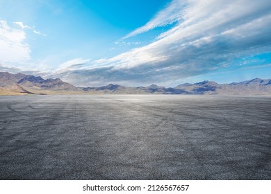 Empty asphalt road and mountain nature scenery under blue sky - Shutterstock ID 2126567657