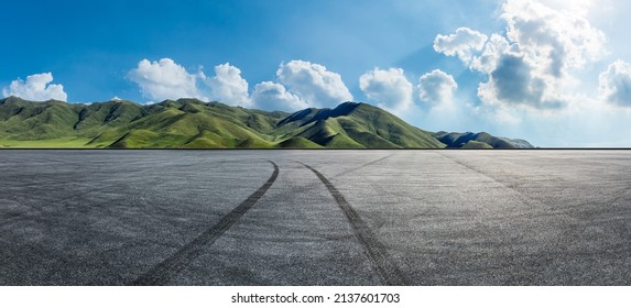 Empty Asphalt Road And Mountain Nature Scenery Under Blue Sky. Road And Mountains Background.