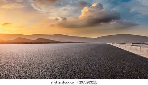 Empty asphalt road and mountain scenery at sunrise - Powered by Shutterstock