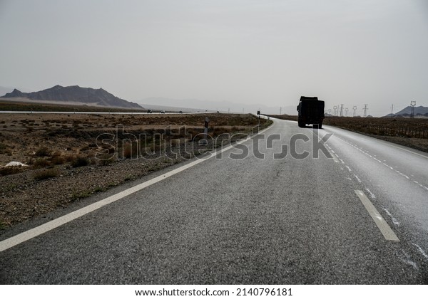 Empty Asphalt road with\
mountains.