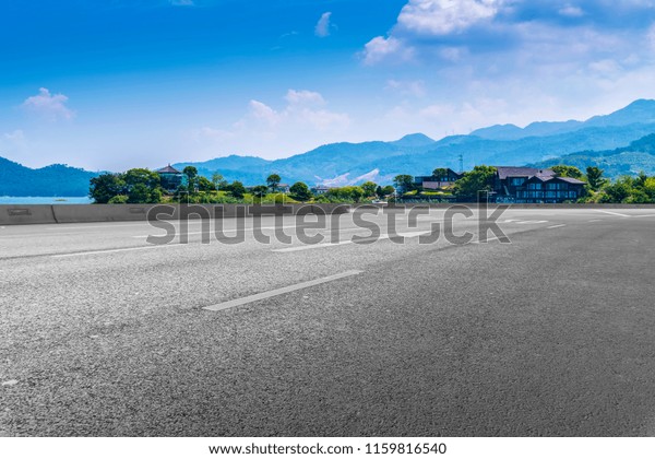 Empty asphalt road and natural landscape under the
blue sky