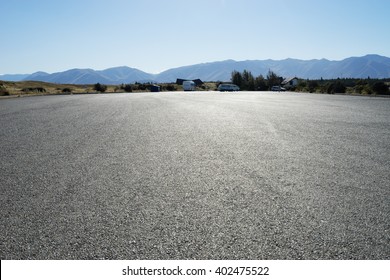 Empty Asphalt Road Near Mountains In New Zealand