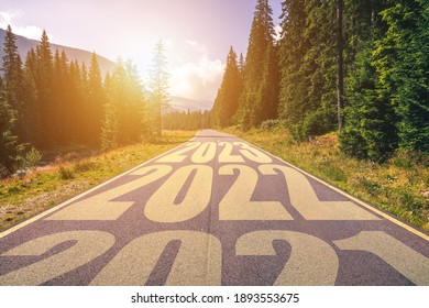 Empty asphalt road and New year 2021, 2022, 2023 concept. Driving on an empty road in the mountains to upcoming 2021, 2022, 2023 and leaving behind old years. Concept for success and passing time.